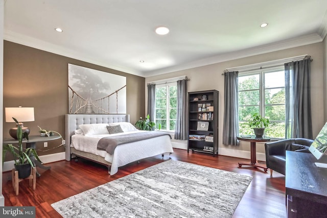 bedroom featuring crown molding and dark wood-type flooring