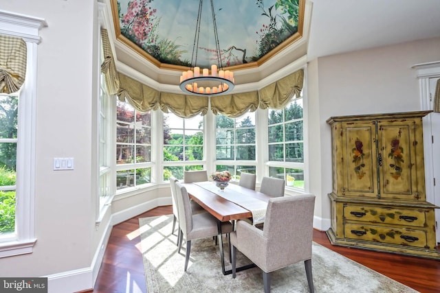 dining room featuring an inviting chandelier, dark hardwood / wood-style floors, crown molding, and a healthy amount of sunlight