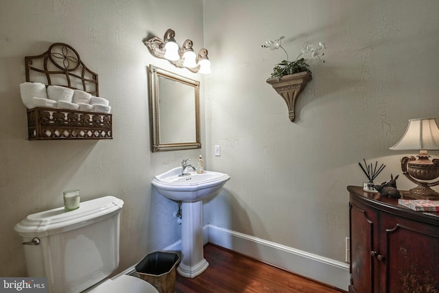 bathroom featuring toilet and hardwood / wood-style flooring