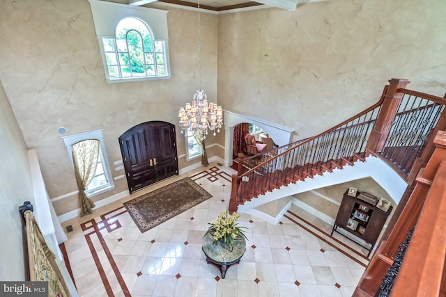 foyer entrance featuring a high ceiling and an inviting chandelier