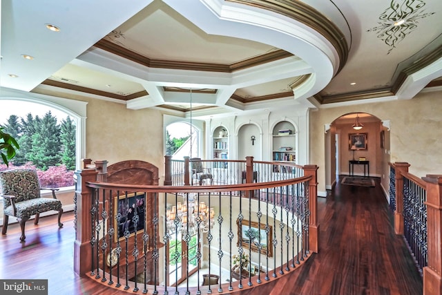 hallway with a chandelier, hardwood / wood-style floors, crown molding, and coffered ceiling