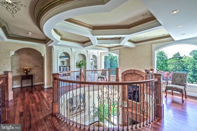 corridor featuring dark hardwood / wood-style flooring, coffered ceiling, and ornamental molding