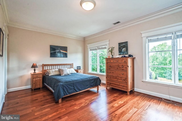 bedroom featuring crown molding and dark hardwood / wood-style flooring