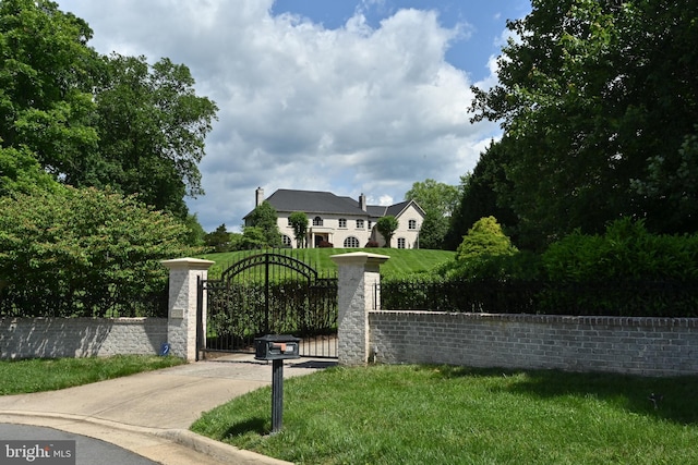 view of gate with a yard