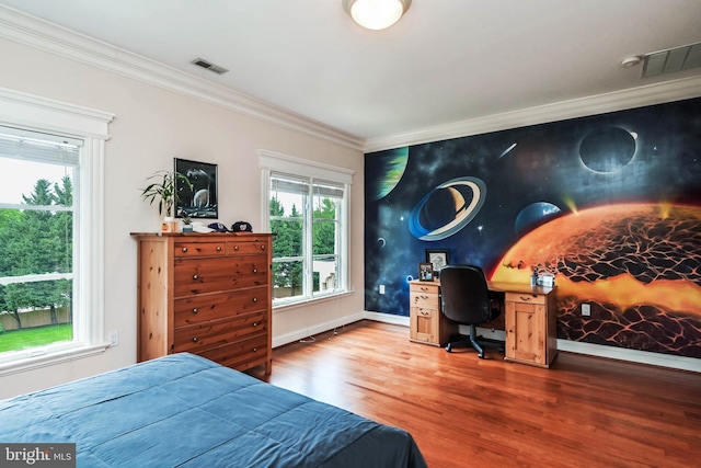 bedroom with crown molding and hardwood / wood-style floors