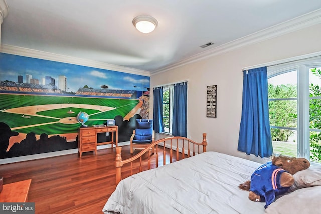 bedroom featuring multiple windows, ornamental molding, and hardwood / wood-style flooring