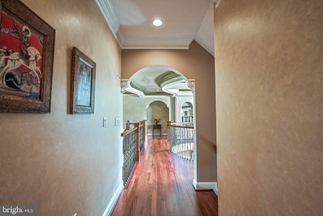 hall with wood-type flooring and ornamental molding