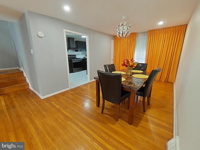 dining area featuring a chandelier and light hardwood / wood-style flooring