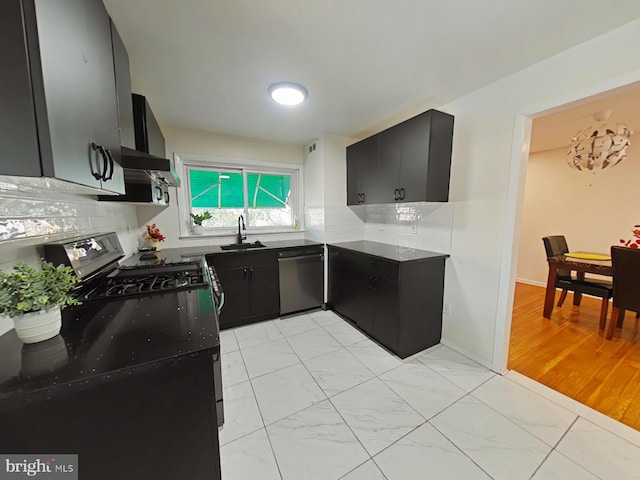 kitchen featuring light hardwood / wood-style flooring, black appliances, sink, and tasteful backsplash