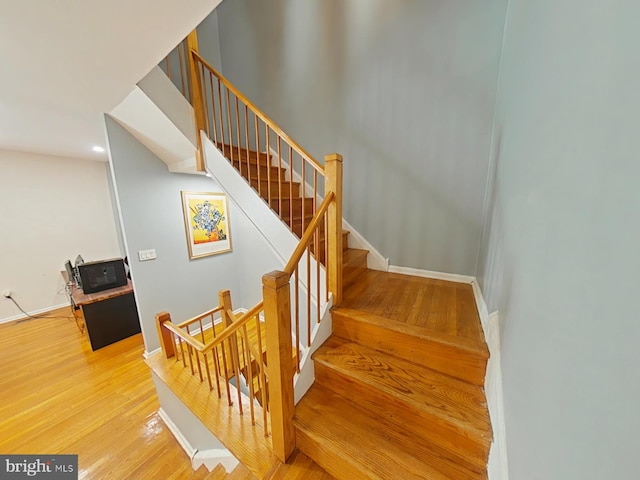 stairs featuring hardwood / wood-style floors