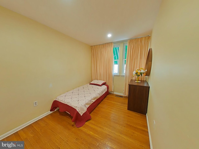 bedroom with light hardwood / wood-style floors