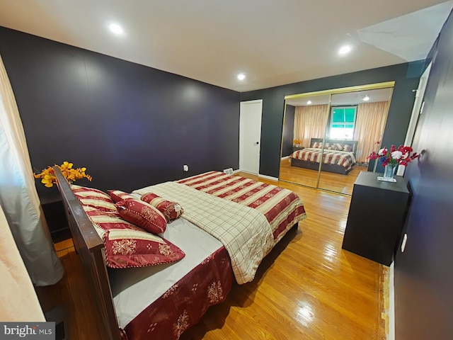 bedroom with hardwood / wood-style flooring and a closet