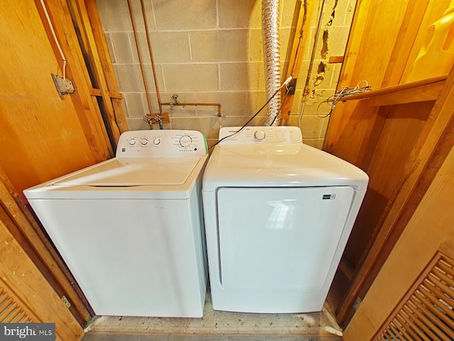 clothes washing area with washing machine and clothes dryer