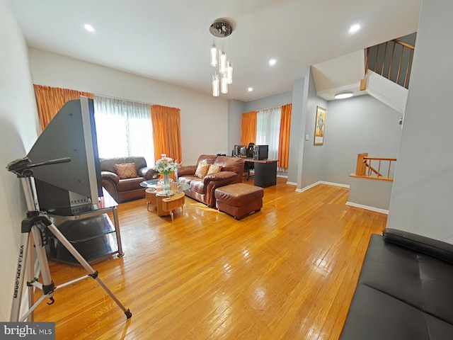 living room featuring an inviting chandelier and light hardwood / wood-style floors