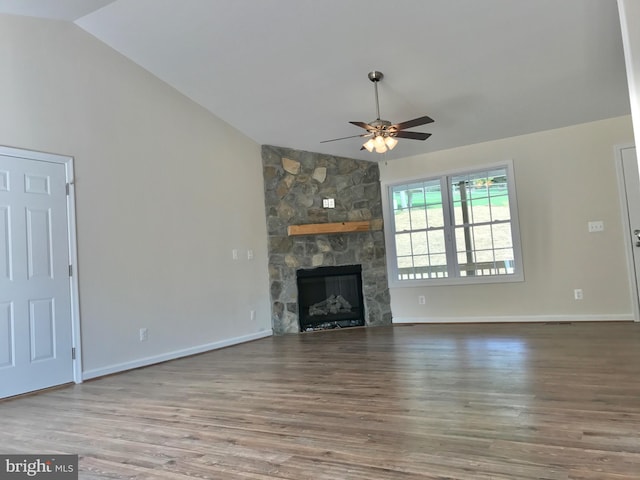 unfurnished living room with a fireplace, ceiling fan, vaulted ceiling, and hardwood / wood-style floors