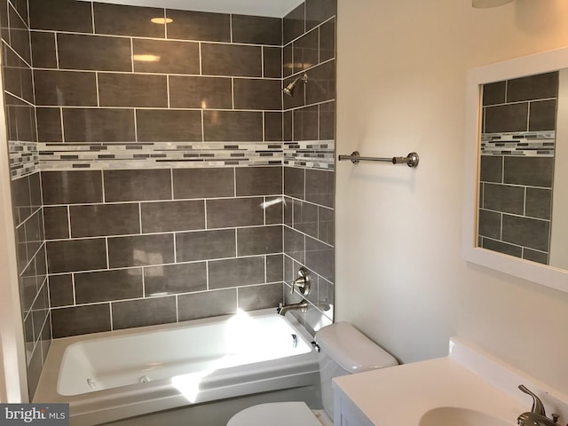 full bathroom with tiled shower / bath, sink, and toilet