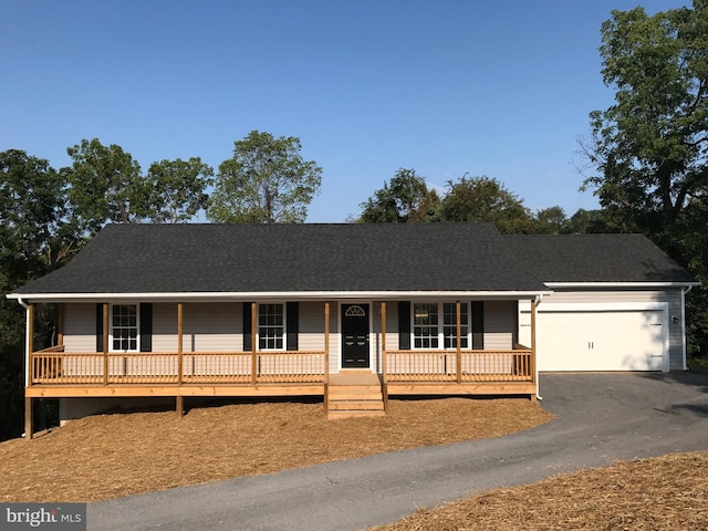 view of front of property with a garage and covered porch