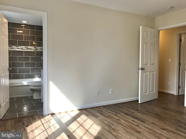 spare room with dark hardwood / wood-style floors