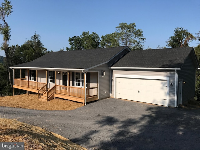 ranch-style home featuring a porch and a garage