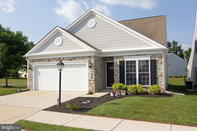 view of front facade with central air condition unit, a front lawn, and a garage