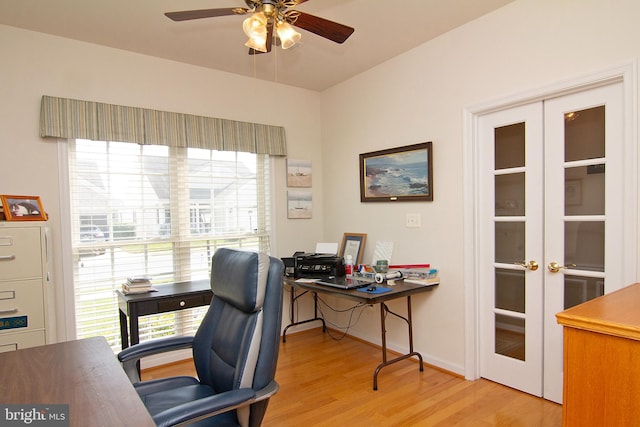 office space featuring french doors, light wood-type flooring, and ceiling fan