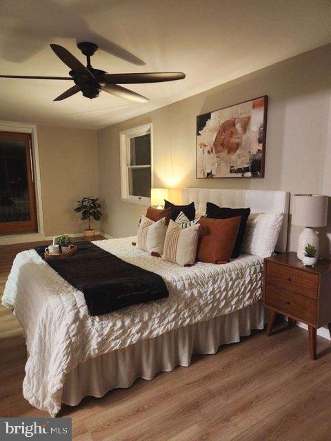 bedroom with ceiling fan and hardwood / wood-style flooring