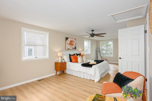 2142 Lake Dr, Pasadena, MD 21122 - bedroom with attic access, light wood-style flooring, baseboards, and ceiling fan