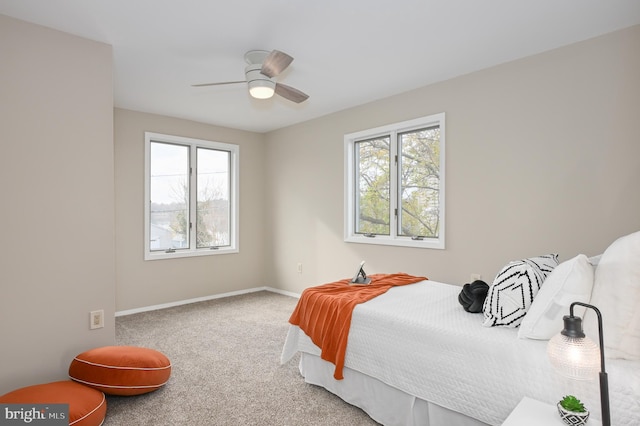 bedroom with carpet flooring, multiple windows, and ceiling fan