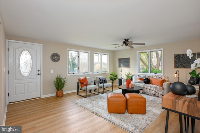 2142 Lake Dr, Pasadena, MD 21122 - living area featuring a ceiling fan, light wood-style flooring, and baseboards
