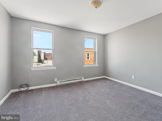 carpeted spare room with a wealth of natural light and a baseboard radiator