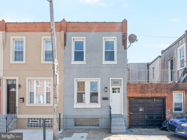 townhome / multi-family property featuring a garage