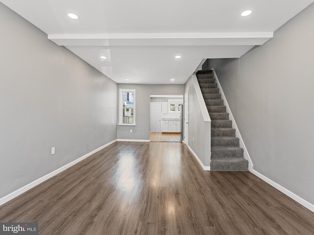 unfurnished living room with dark wood-type flooring