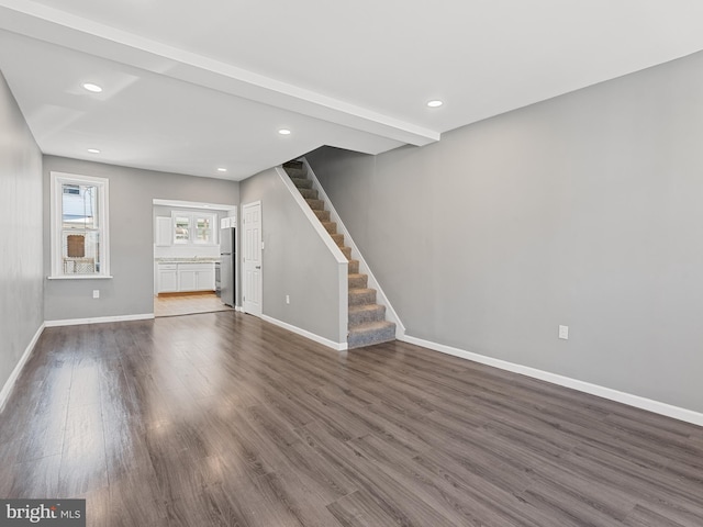 unfurnished living room with dark hardwood / wood-style floors