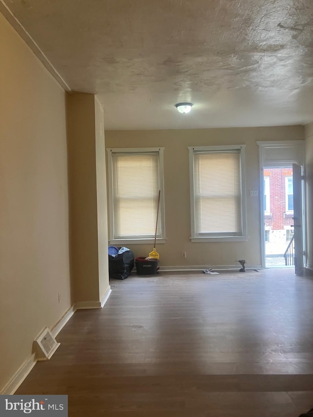 unfurnished room with hardwood / wood-style flooring