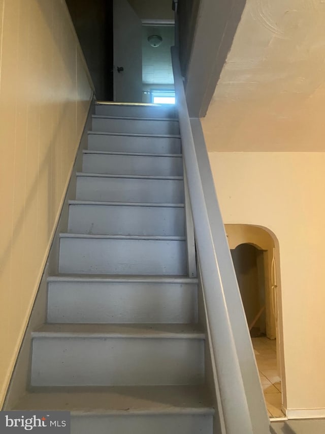 stairs featuring tile patterned floors