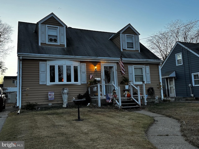 new england style home featuring a front lawn