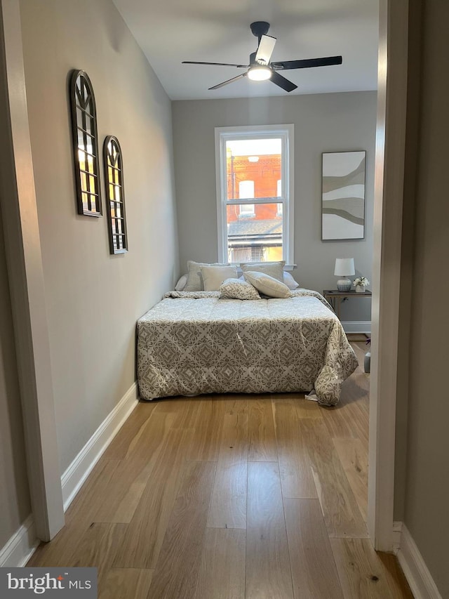 bedroom featuring hardwood / wood-style flooring and ceiling fan