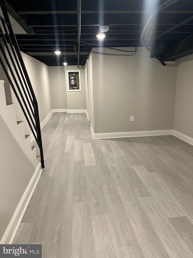 basement with light hardwood / wood-style floors