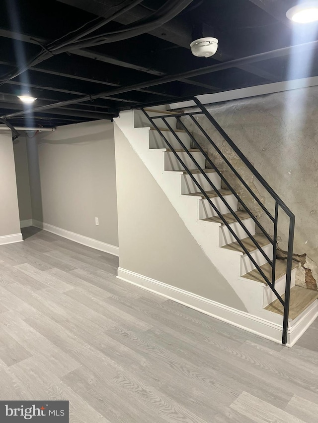 basement featuring wood-type flooring