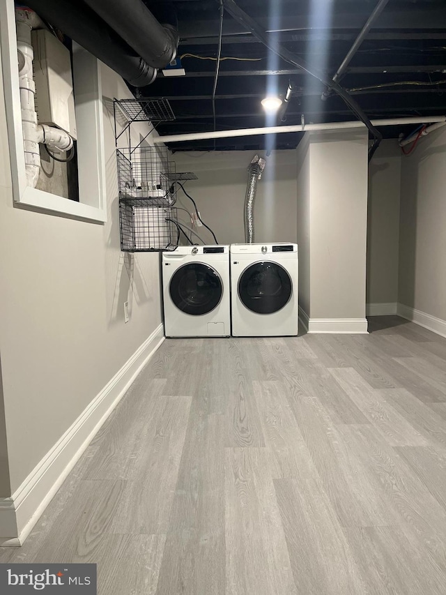 laundry room with hardwood / wood-style floors and independent washer and dryer