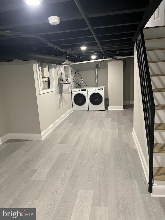 washroom featuring washer and clothes dryer and light hardwood / wood-style flooring