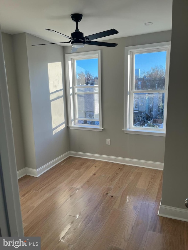 unfurnished room with ceiling fan and light hardwood / wood-style flooring