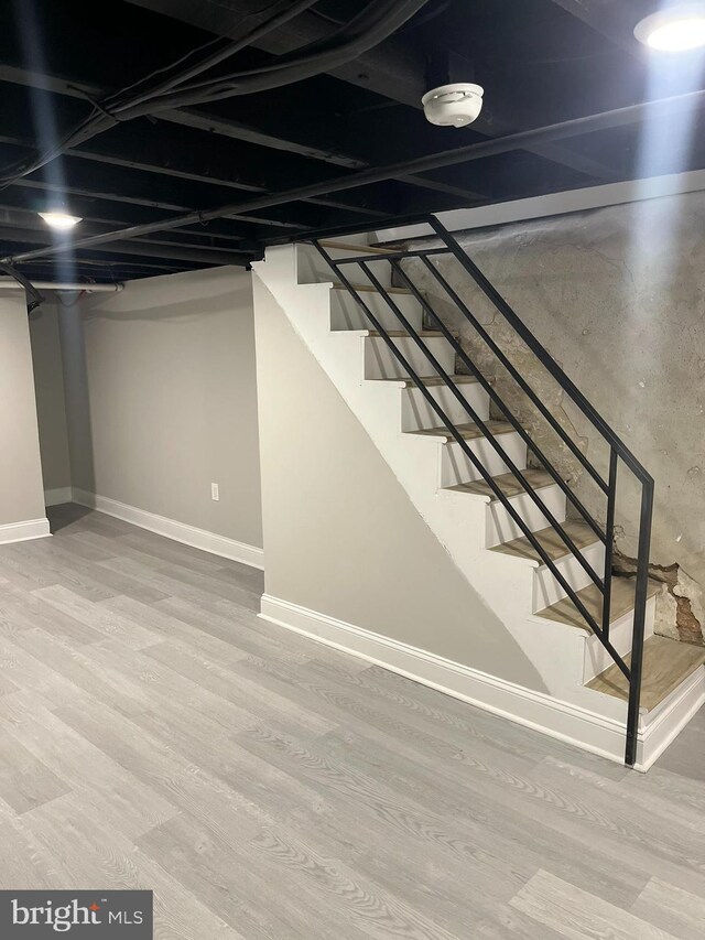 basement with hardwood / wood-style flooring