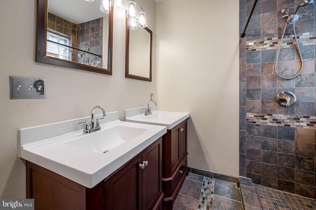 bathroom featuring a tile shower and vanity