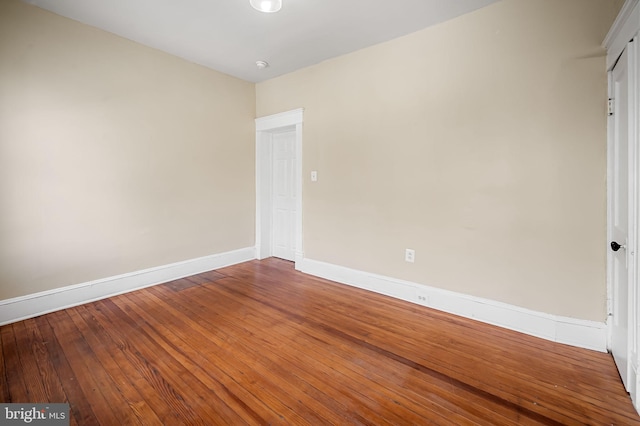 spare room with hardwood / wood-style flooring