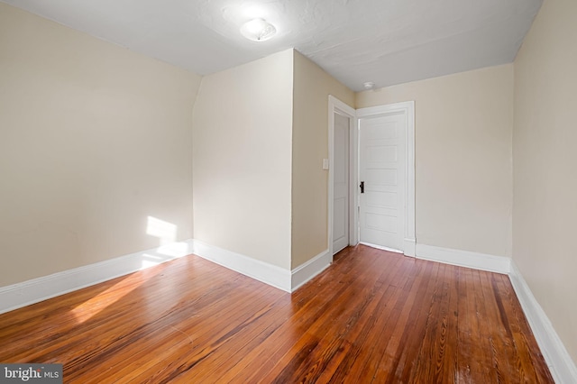 spare room with dark hardwood / wood-style flooring