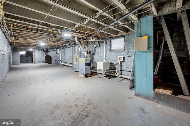 basement with gas water heater and sink