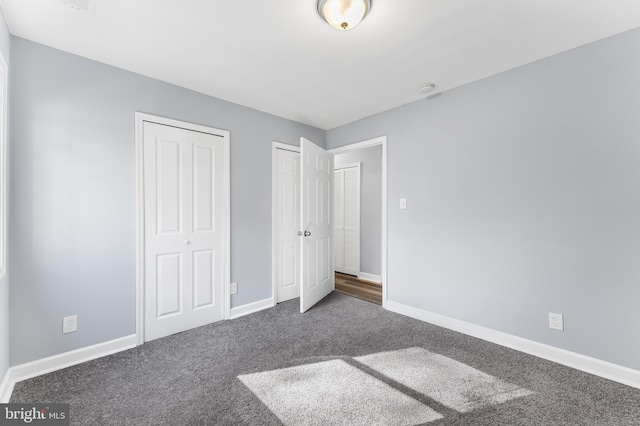 unfurnished bedroom with dark colored carpet