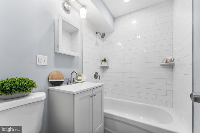 full bathroom with vanity, tiled shower / bath combo, and toilet