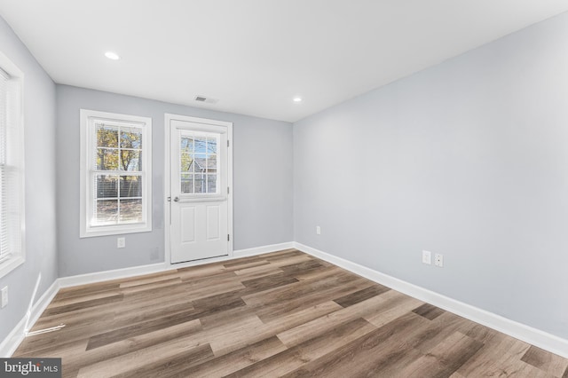 empty room with hardwood / wood-style flooring